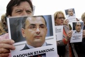 Women from the Association of Women Victims of War, carry photos of Radovan Stankovic during protests in Sarajevo on 30 May 2007.